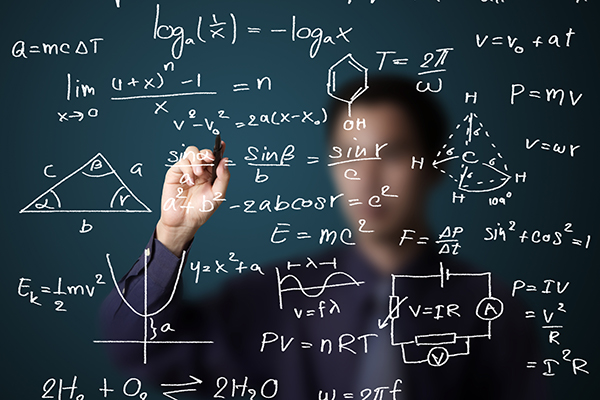 man doing math on a board