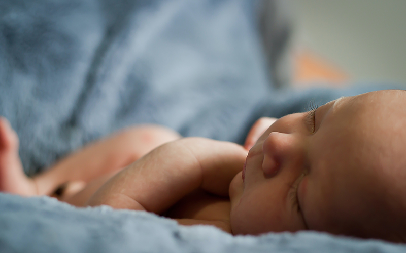 Infant lying on blanket