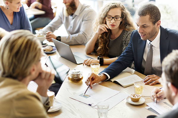 Employees collaborating on a project at a table