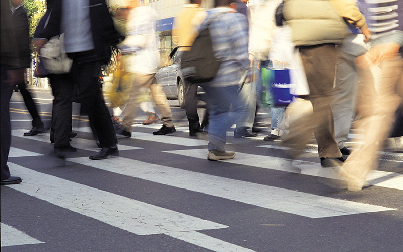 Crowd crossing a busy street